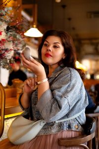 zhenshhina-v-kafe-za-barnoj-stojkoj-popravljaet-makijazh женщина в кафе за барной стойкой поправляет макияж